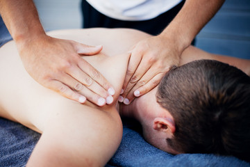 Fototapeta na wymiar Sports therapist giving a massage to a injured athlete