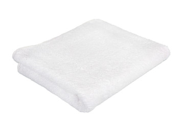 A clean white Terry towel. Terry towel on a white background. Accessories for the bath. Cotton products. Towel made of bamboo fiber.