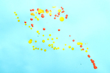 Random color oil paint splashes on blue paper. Seamless colorful background. Oil paint dots on blue background. 