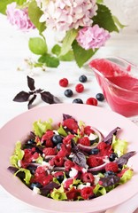 Salad with berries with vinaigrette. Vegetarian salad with raspberries and blueberries. homemade berry vinaigrette. 