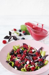 Salad with berries with vinaigrette. Vegetarian salad with raspberries and blueberries. homemade berry vinaigrette. 
