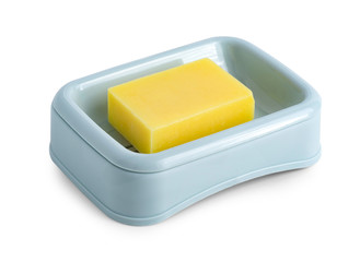 plastic blue soap holder with yellow soap on white background