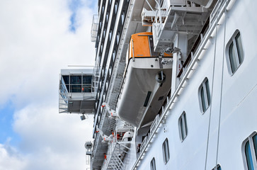 View up to the bridge and the rescue boats of a large cruise ship