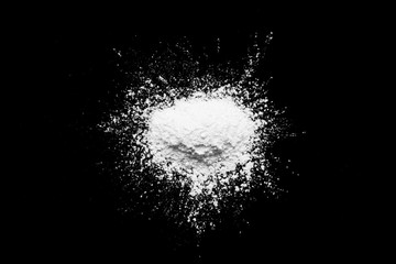 Fototapeta na wymiar White powder isolated on the black background.
