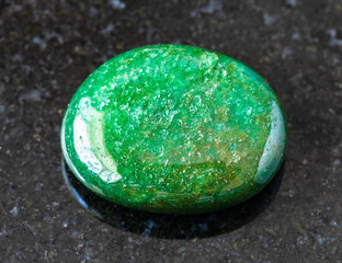 closeup of sample of natural mineral from geological collection - tumbled green Aventurine gem...