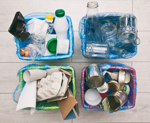 The four different container for sorting garbage. For plastic, paper, metal and glass