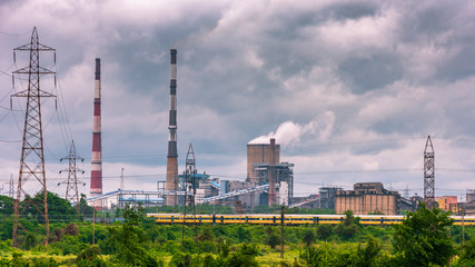 Fototapeta premium View of Cooling Tower and Chimneys with Moody Sky.