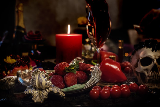 Exquisite table with strawberries and decorative items of luxury and sophistication. Dark glamorous photo.