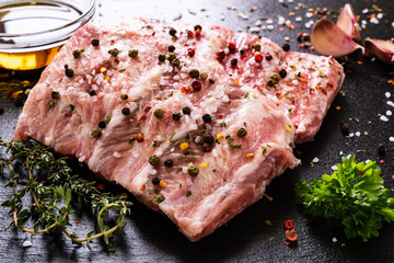 Raw pork ribs on black stone cutting board
