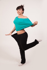 Happy young woman after weight loss. Diet and fitness. Healthy lifestyle. Liposuction .. Nutrition Concept. Lifting. 