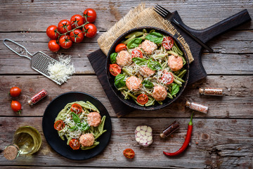 Delicious fresh pasta with meatballs, sauce, cherry tomatoes and basil