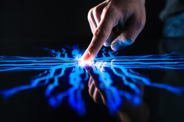Digitalization Concept: Human Finger Pushes Touch Screen Button and Activates Futuristic Artificial...
