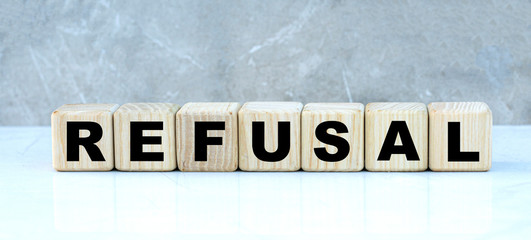 concept of the word REFUSAL on cubes on a gray background