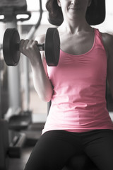 Fototapeta na wymiar Young woman training in the gym happy