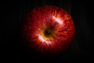 red apple on black background