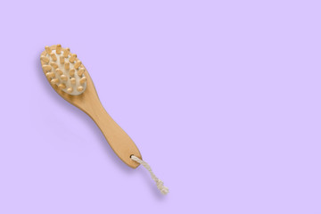 top view brush for dry skin massage on a pastel violet background,copy space