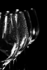 Wine glass on black with water drops