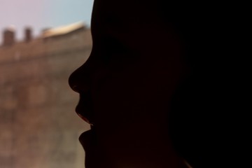 silhouette of a child's face in backlight
