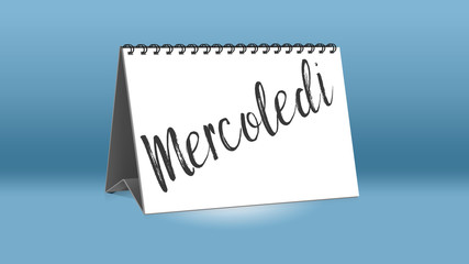 Ein Kalender für den Schreibtisch zeigt den italienischen Wochentag Mercoledi (Mittwoch in deutscher Sprache)