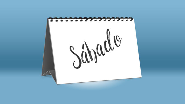Ein Kalender für den Schreibtisch zeigt den spanischen Wochentag Sabado (Samstag in deutscher Sprache)