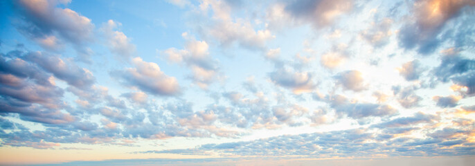 Blue sky clouds background. Beautiful landscape with clouds and orange sun on sky
