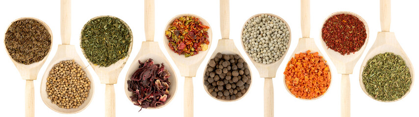 Collection of spices in wooden spoons, isolated on white
