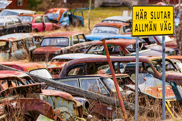 Bastnas, Sweden - APRIL 04, 2020: Old vehicles left in nature at the end of the road at Ivan's Junk Yard - a deserted car cemetery far out in the Swedish woods