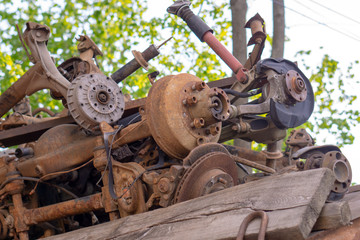 rusty spare parts for cars lying in a pile