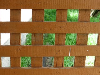 view of the village through a wooden lattice