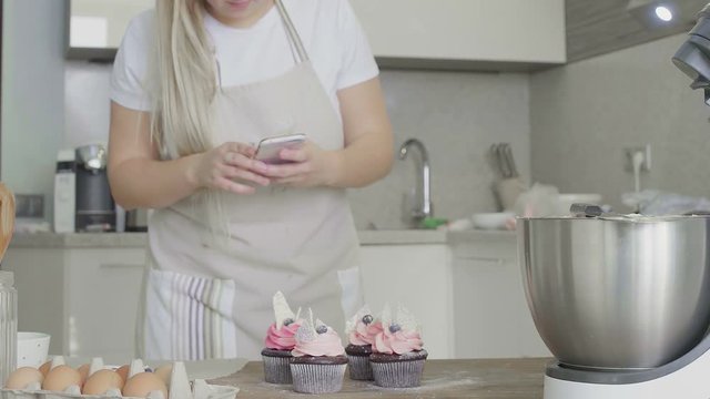Woman makes photo of her cupcake.