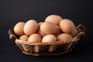 eggs in basket on black background