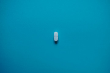 White pills  on a paper background with a free area for text
