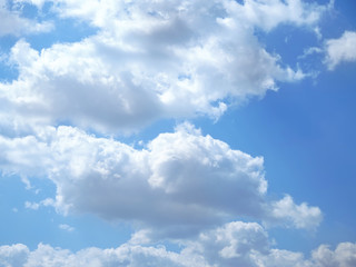Naklejka na ściany i meble White cumulus clouds on a blue sky