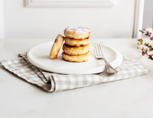 Breakfast in the morning. Cottage cheese pancakes with jam  on white plate. Russian, Ukrainian cuisine.