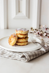 Breakfast in the morning. Cottage cheese pancakes with jam  on white plate. Russian, Ukrainian cuisine.