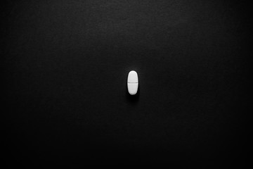 White pills  on a paper background with a free area for text