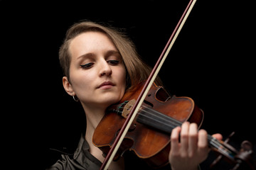 Professional woman violinist playing a violin