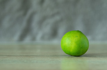 Fresh green lemons on the table