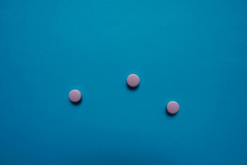 White pills  on a paper background with a free area for text