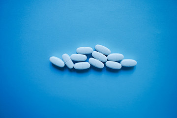 White pills  on a paper background with a free area for text