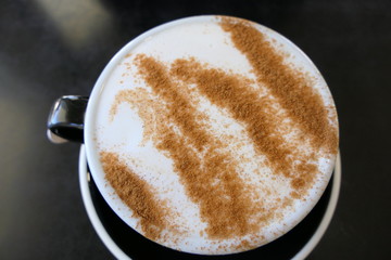 Delicious chai latte prepared with cinnamon on the top