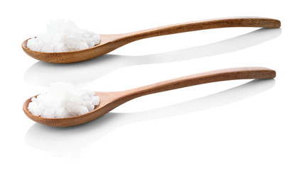 Sea salt on a wooden spoon isolated on a white background Beautiful lines For salty seasoning