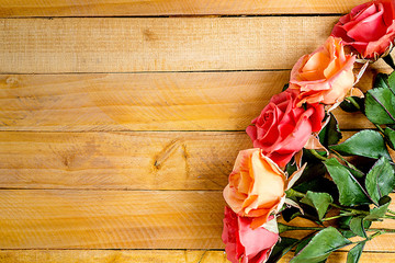 Handmade roses layout on wooden background. Background layout with free text space.