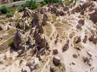 Aerial view of Goreme National Park, Goreme Tarihi Milli Parki, Turkey. The typical rock formations of Cappadocia with fairy chimneys and desert landscape. Travel destinations, holidays and adventure