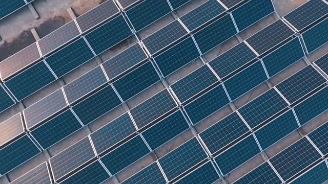 Top view of a new solar farm. Rows of modern photovoltaic solar panels. Renewable ecological source of energy from the sun. Aerial view.