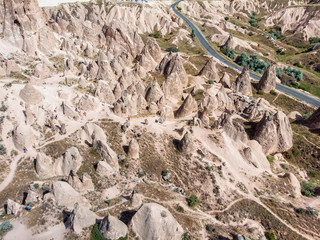 Aerial view of Goreme National Park, Goreme Tarihi Milli Parki, Turkey. The typical rock formations of Cappadocia with fairy chimneys and desert landscape. Travel destinations, holidays and adventure