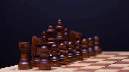 Wooden chess in a contrasting light. A game of chess, an intellectual competition,