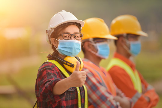 Corona Or Covid-19 Wear Masks During The Design Of Construction. New Normal.Industrial Engineering Team Wears A COVID 19 Protective Mask. Workers Wear A Quarantine Face Mask.