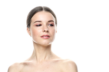 A close-up portrait of a girl with freckles and clear skin. Light blue eyes. The girl has different emotions, she looks at the camera. Isolated on a white background 