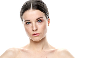 Obraz premium A close-up portrait of a girl with freckles and clear skin. Light blue eyes. The girl has different emotions, she looks at the camera. Isolated on a white background 